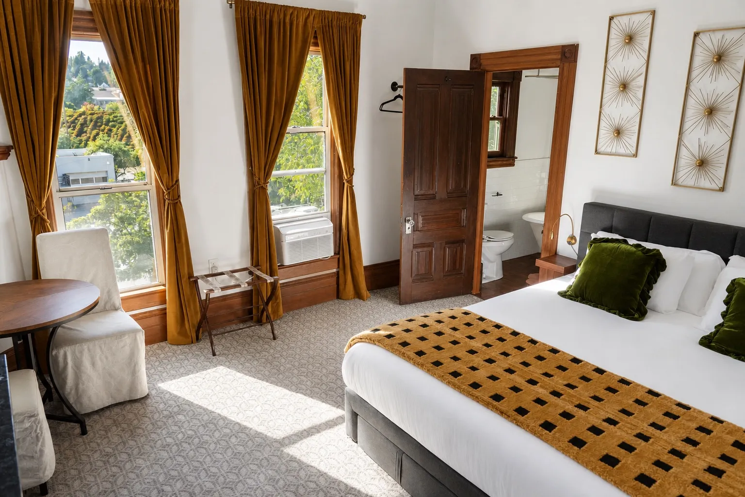 Gold Center: a king bed, tall windows with gold velvet curtains and an open door to the ensuite